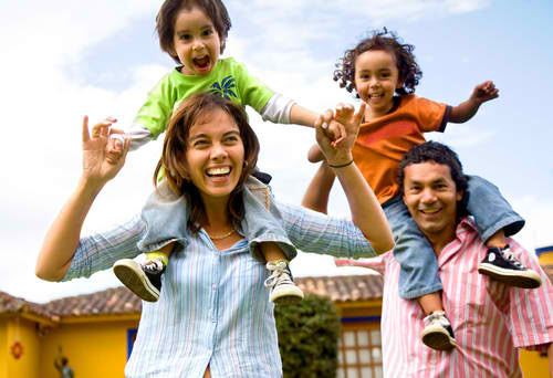 mom and dad with kids on shoulders